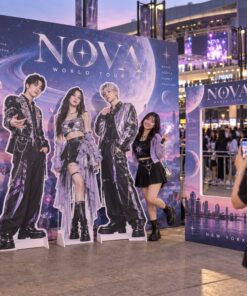 Concert photo zone with artist standees, album concept backdrop and oversized photocard frame